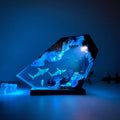 Decorative lamp with underwater scene and glowing blue light on a dark background