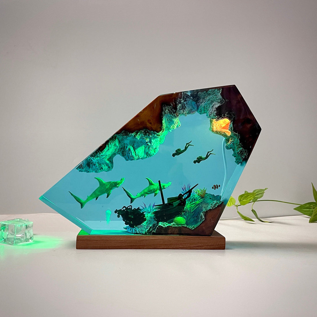 Decorative lamp with underwater scene and glowing blue light on a dark background